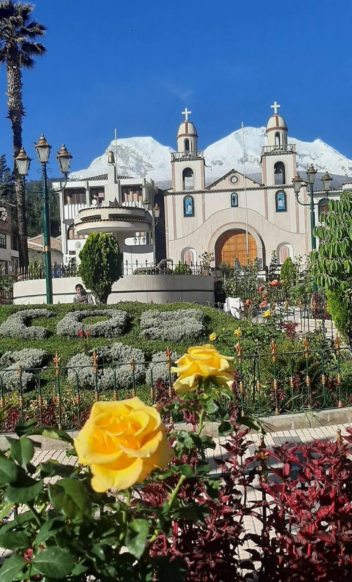 Mancos main square with roses and the church behind
